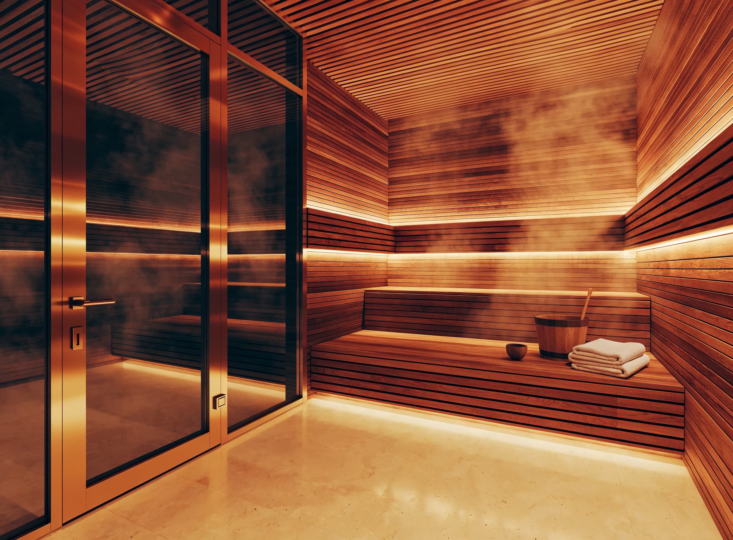 The sauna: cedar slatted walls and tiered benches, cove lighting behind the slats, steam in the air